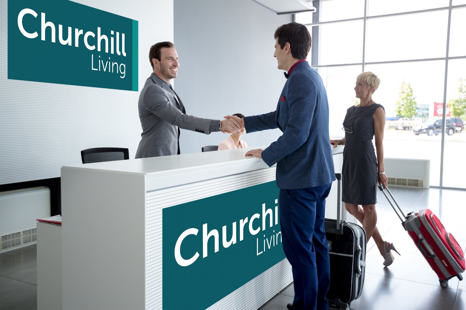 Guests being welcomed at a Churchill Living reception desk